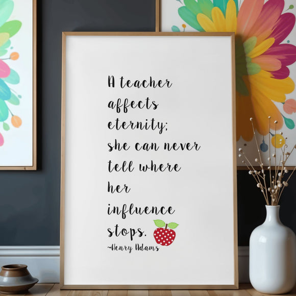 A framed typographic wall art print for a teacher with a black quote on a white background, styled on a wooden shelf with a red apple, pencils, a notebook, and a potted plant. Teacher appreciation gift.